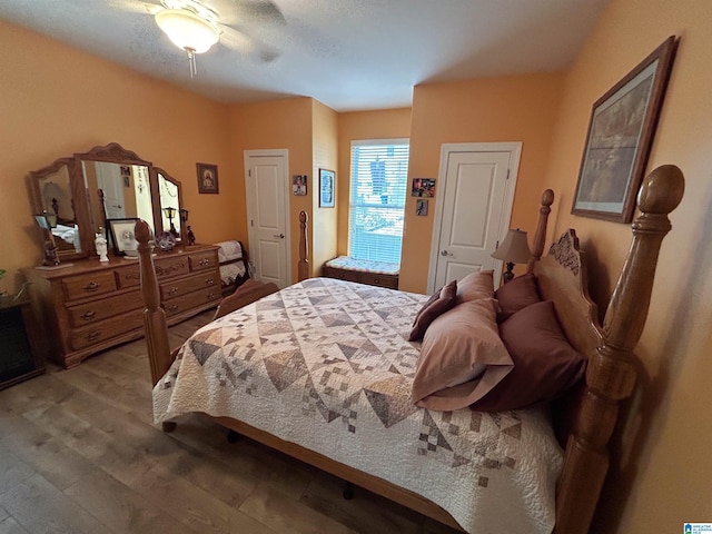 bedroom with ceiling fan and hardwood / wood-style flooring