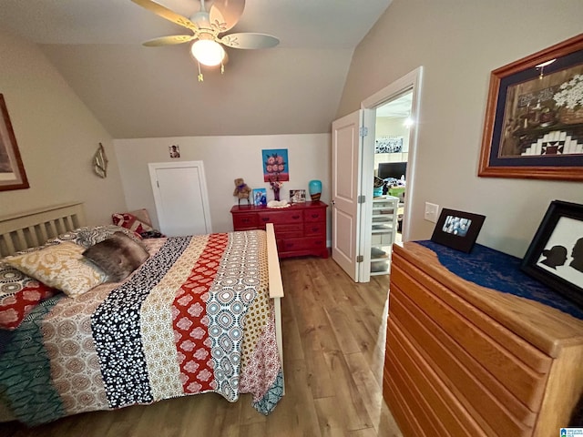 bedroom featuring ceiling fan, vaulted ceiling, and light wood-type flooring