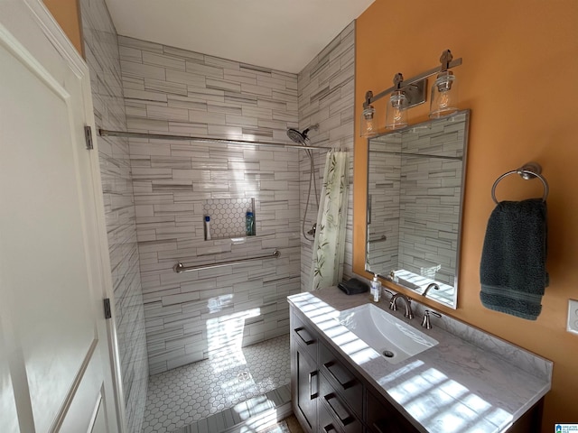 bathroom with a shower with curtain, vanity, and tile patterned floors