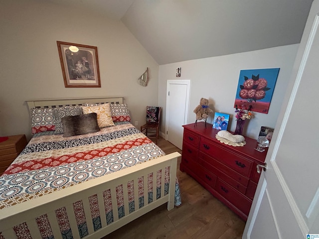 bedroom featuring hardwood / wood-style flooring and vaulted ceiling