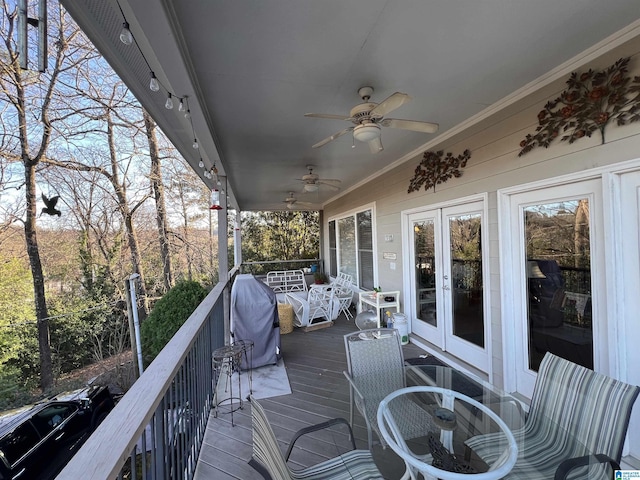 wooden deck with a grill, ceiling fan, and french doors