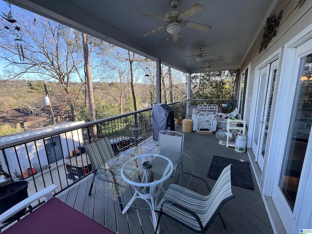 wooden terrace with area for grilling and ceiling fan