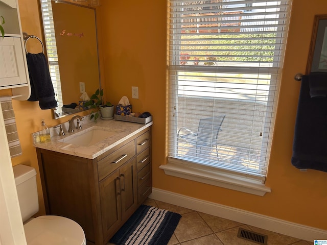 bathroom with tile patterned floors, vanity, and toilet