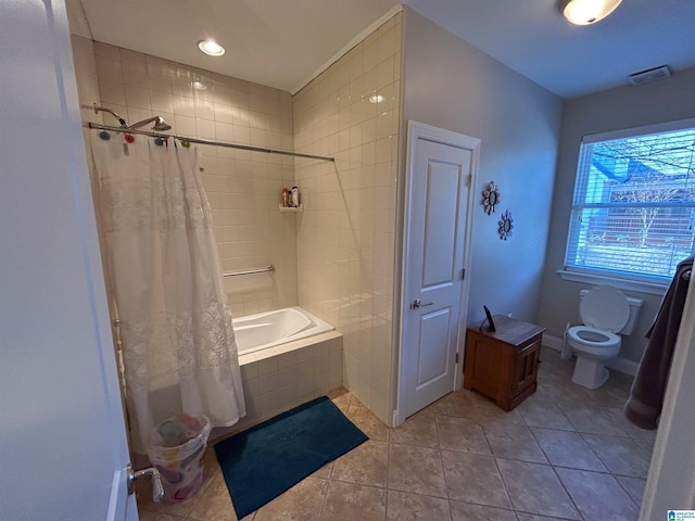 bathroom with tile patterned flooring, shower / bath combination with curtain, and toilet