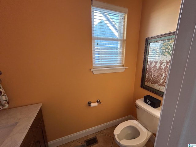 bathroom featuring tile patterned flooring, vanity, and toilet