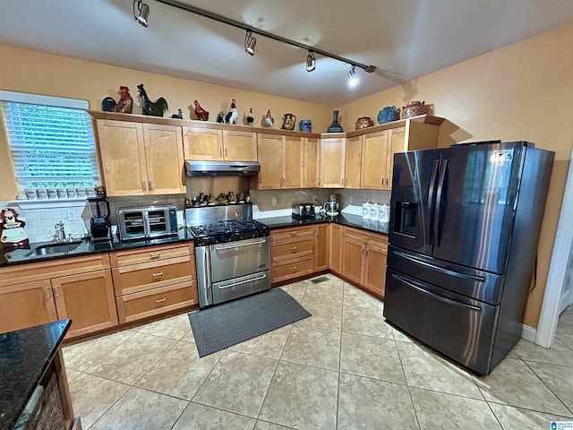 kitchen with refrigerator with ice dispenser, sink, light tile patterned flooring, and stainless steel gas range