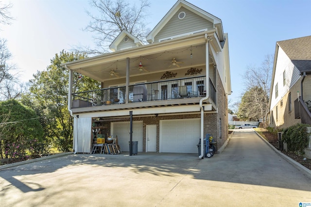 exterior space featuring ceiling fan, a balcony, and a garage