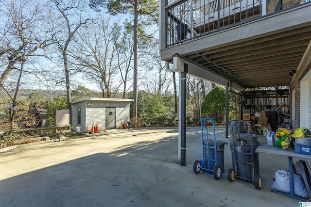 view of patio with a balcony and a shed