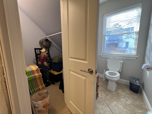 bathroom with toilet and tile patterned floors