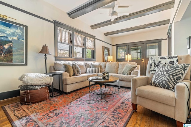 living room with hardwood / wood-style floors, ceiling fan, and beam ceiling