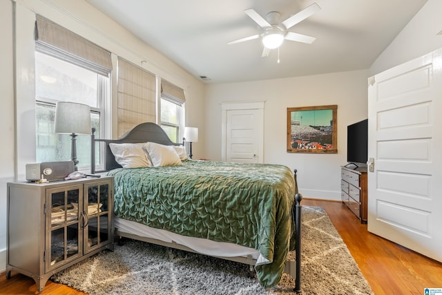 bedroom with hardwood / wood-style flooring and ceiling fan