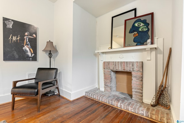 living area featuring a fireplace and wood-type flooring