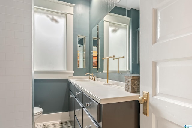 bathroom with tile patterned flooring, vanity, and toilet