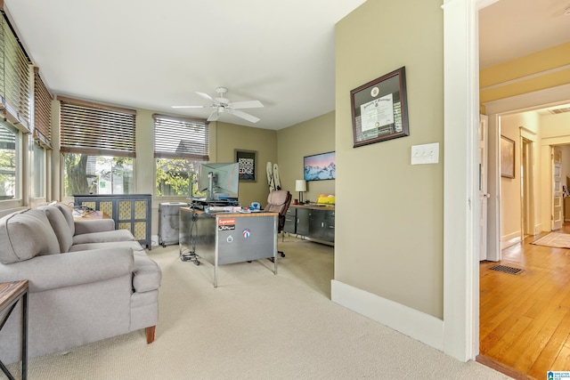 office with ceiling fan and light colored carpet