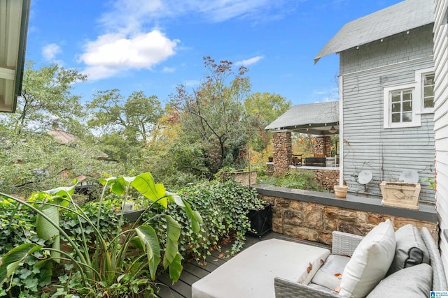 view of patio with ceiling fan, an outdoor hangout area, and a deck