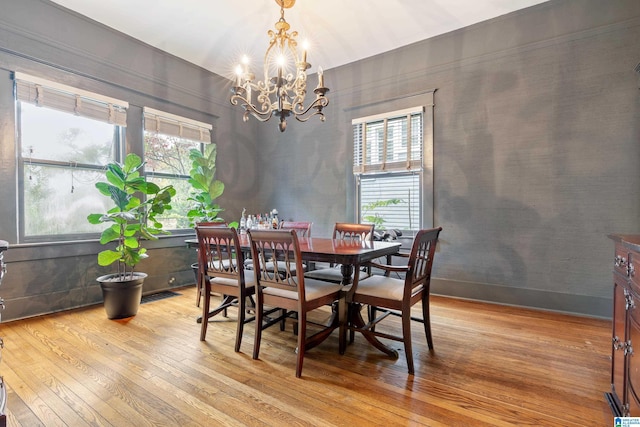 dining area with a chandelier and light wood-type flooring