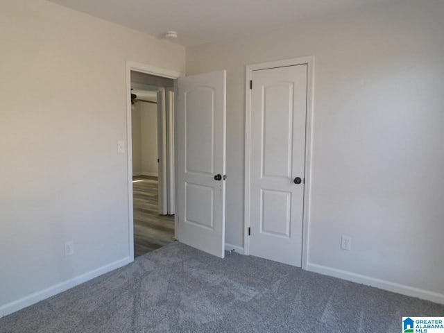 unfurnished bedroom featuring dark colored carpet