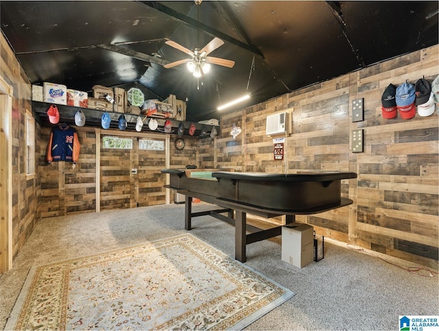 recreation room featuring carpet, vaulted ceiling, ceiling fan, and wooden walls