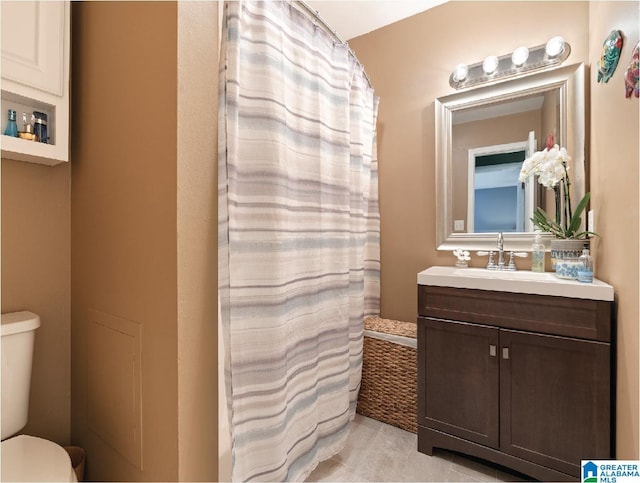 bathroom featuring vanity, toilet, and walk in shower