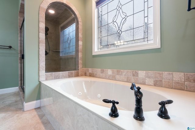 bathroom featuring shower with separate bathtub