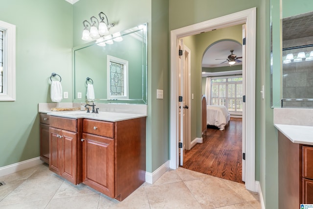 bathroom featuring vanity, crown molding, tile patterned flooring, and ceiling fan