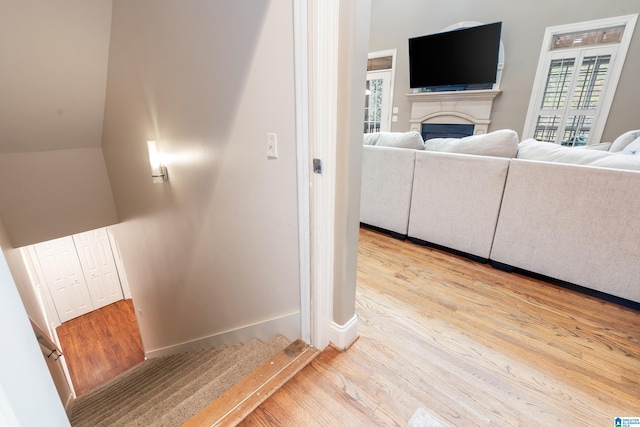 interior space featuring hardwood / wood-style floors and vaulted ceiling