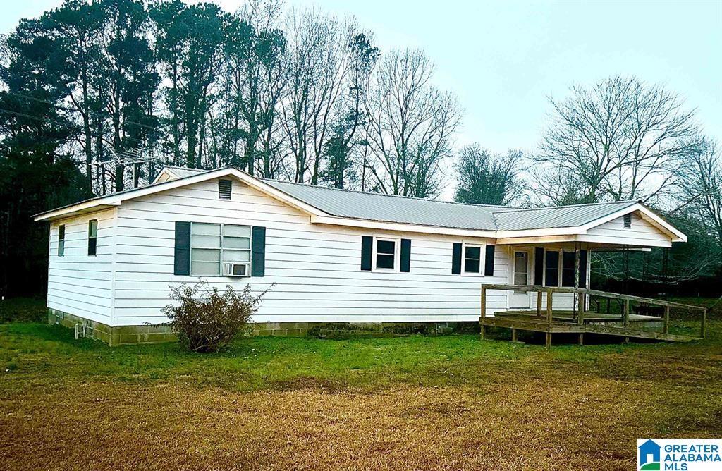 rear view of property with a yard and cooling unit