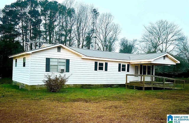 rear view of property with a yard and cooling unit