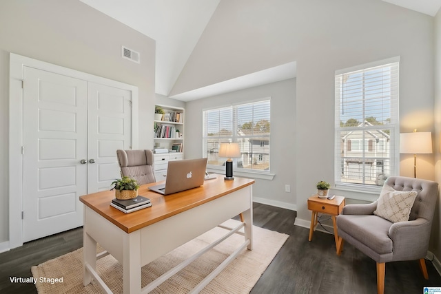 office with built in shelves, dark hardwood / wood-style flooring, and vaulted ceiling