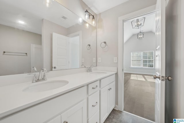 bathroom featuring vanity and vaulted ceiling