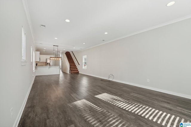 unfurnished living room with dark hardwood / wood-style flooring and ornamental molding