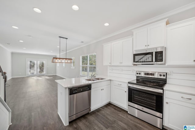 kitchen with kitchen peninsula, sink, white cabinets, and stainless steel appliances