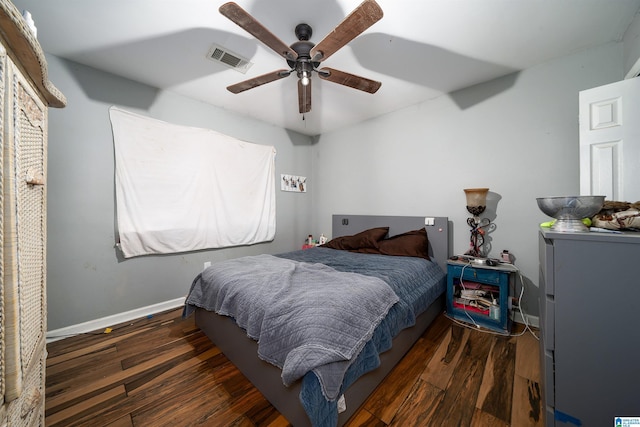 bedroom with dark hardwood / wood-style floors and ceiling fan