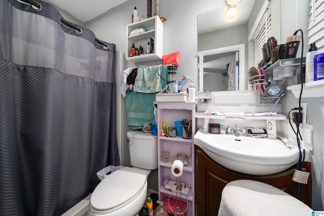 bathroom with toilet, vanity, and walk in shower