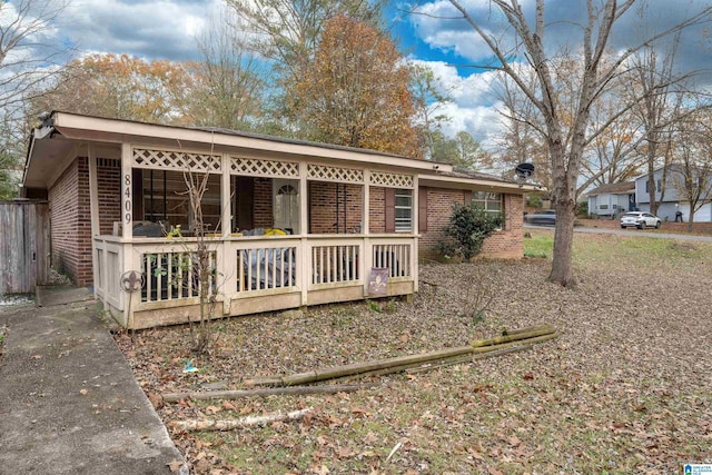 rear view of property featuring covered porch