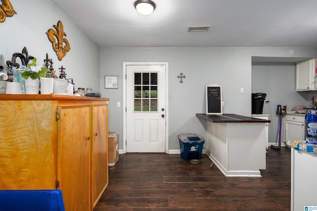 kitchen with white cabinets and dark wood-type flooring