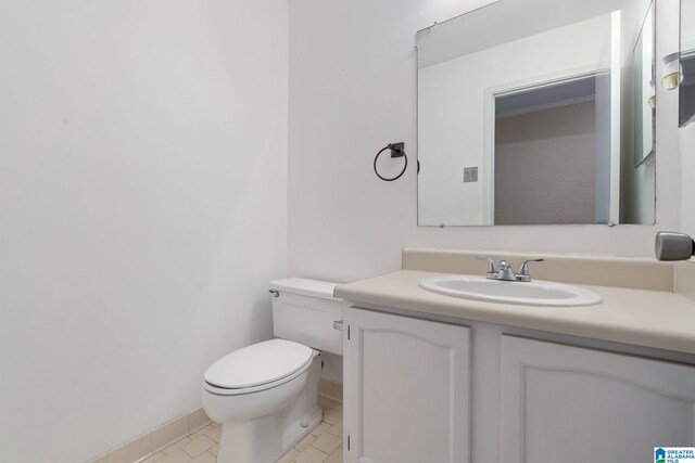 bathroom with tile patterned floors, vanity, and toilet