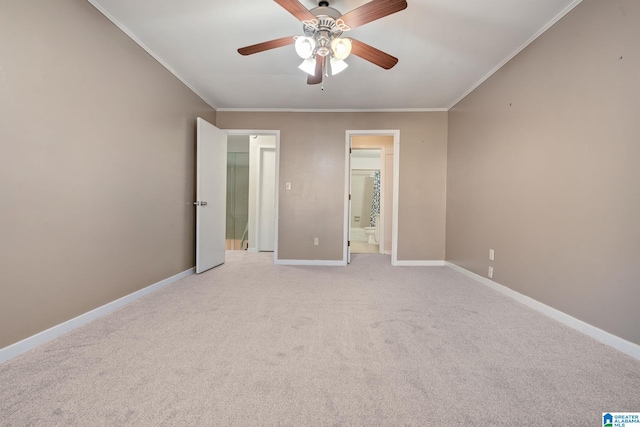 unfurnished bedroom featuring ornamental molding, ensuite bathroom, ceiling fan, and light colored carpet