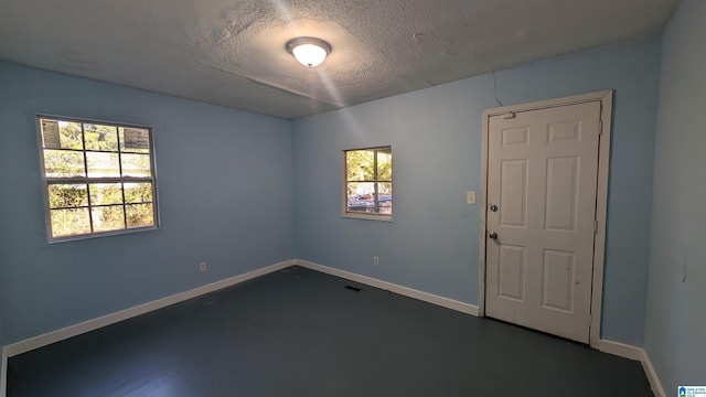 empty room featuring a textured ceiling