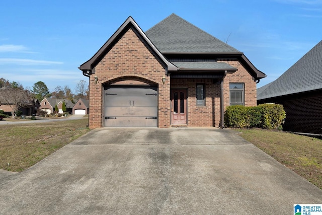 view of front of house with a front lawn and a garage