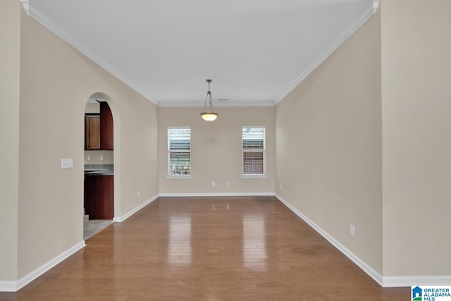 unfurnished dining area featuring crown molding and light hardwood / wood-style flooring