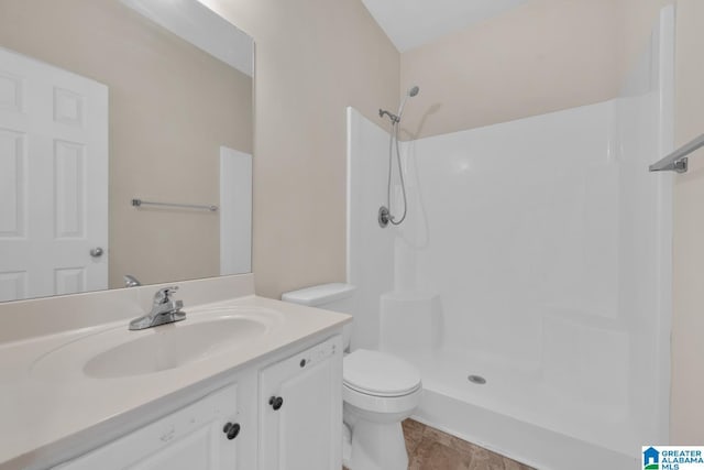 bathroom featuring a shower, vanity, and toilet