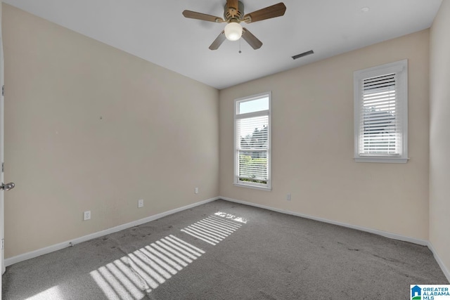 empty room featuring ceiling fan and light colored carpet