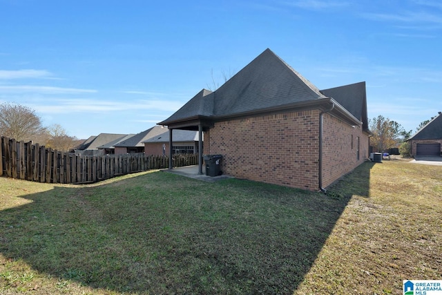 view of property exterior with a yard and central AC