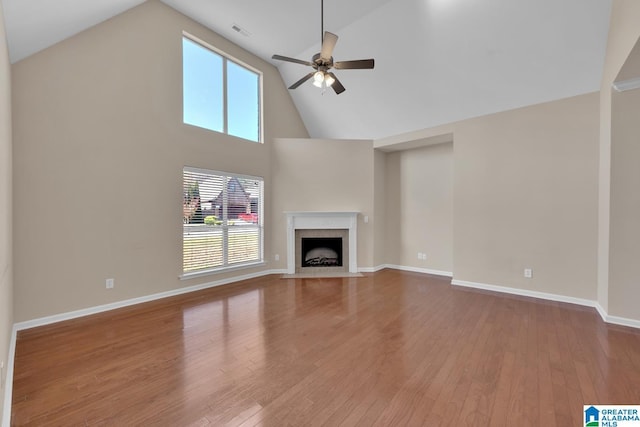 unfurnished living room with ceiling fan, high vaulted ceiling, and hardwood / wood-style flooring