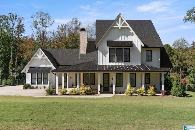 modern farmhouse style home featuring covered porch and a front yard