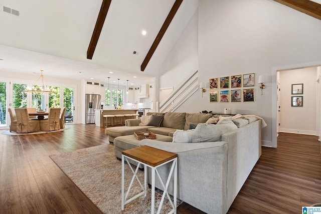 living room with beam ceiling, dark hardwood / wood-style flooring, high vaulted ceiling, and a notable chandelier