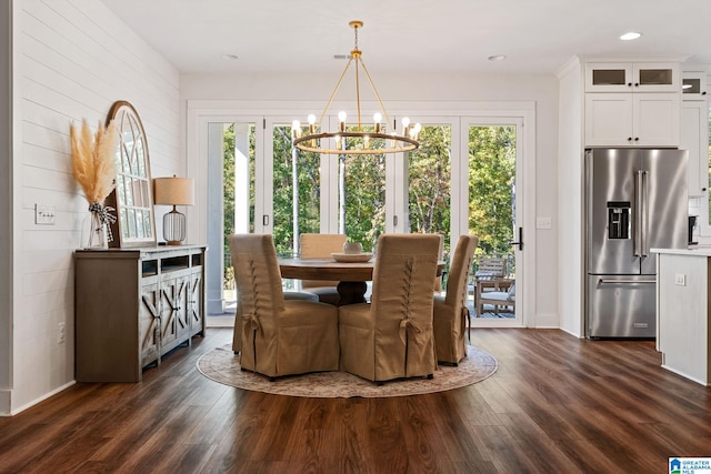 dining room with dark hardwood / wood-style floors, a wealth of natural light, and a chandelier