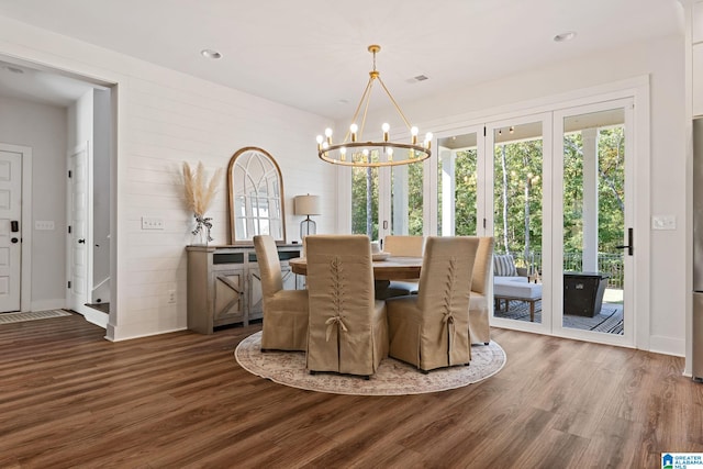 dining room featuring dark hardwood / wood-style flooring and a notable chandelier