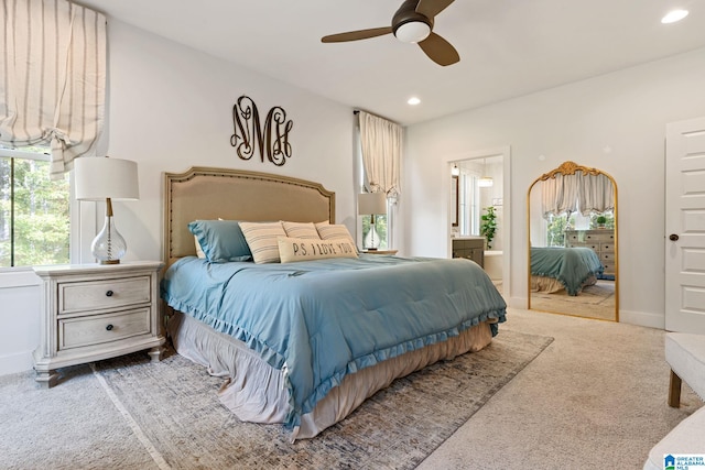 bedroom with connected bathroom, ceiling fan, and carpet